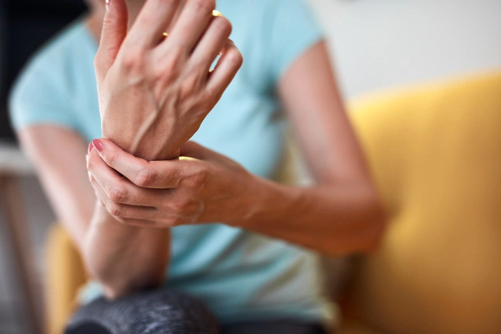 Woman holding wrist in pain