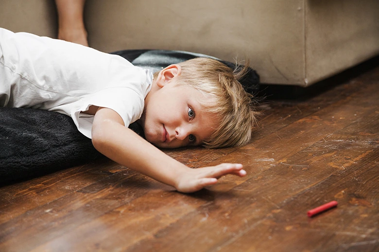 Unavřené dítě leží na podlaze po vzteku.