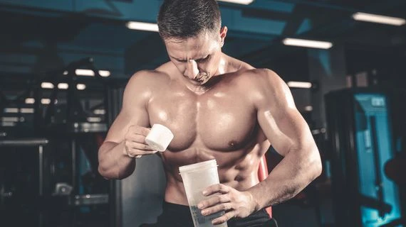 Man pouring protein powder