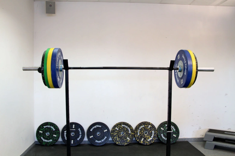 Barbell on squat rack with plates