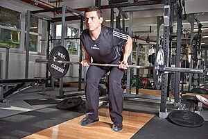 Man performing bent-over row with barbell