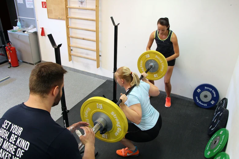 Woman squatting with barbell